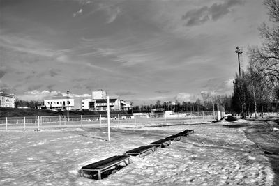 Scenic view of park by building against sky during winter