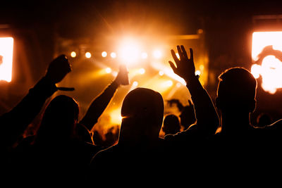 Silhouette people at music concert