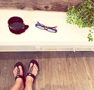 Low section of woman standing on hardwood floor