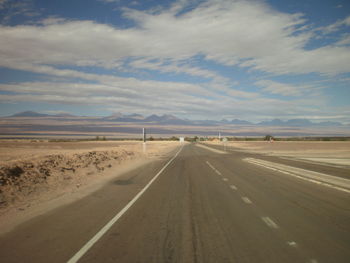 Empty road with mountain in background