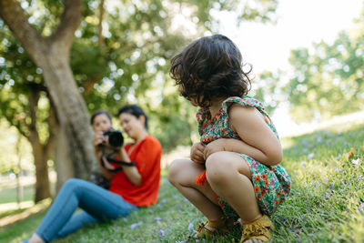 Rear view of couple sitting on land