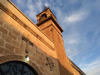 Low angle view of clock tower against sky