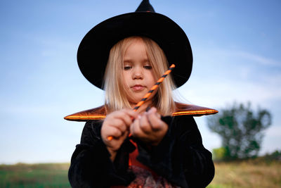 Portrait of girl wearing hat against sky