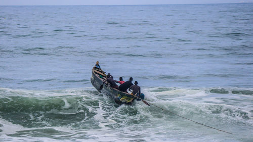 People in boat on sea