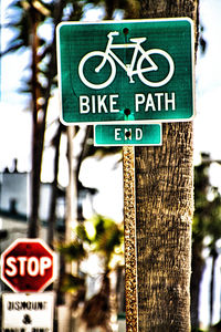 Close-up of road sign against trees