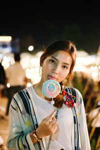 Portrait of young woman standing outdoors