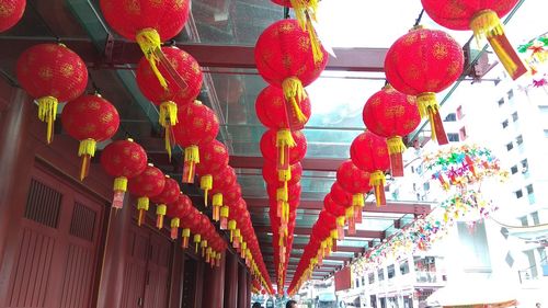 Low angle view of lanterns hanging on wall