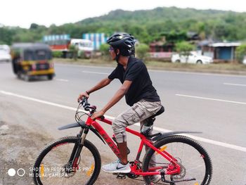 Man riding bicycle on road