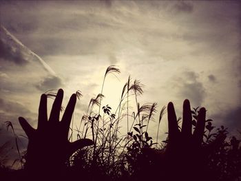 Silhouette of landscape against cloudy sky