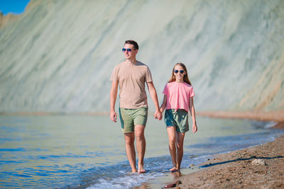 Full length portrait of woman on sea shore