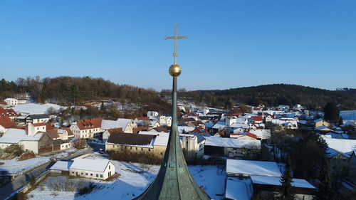 Scenic view of town against clear blue sky