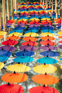 Low angle view of multi colored umbrellas hanging on clothesline