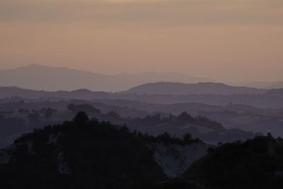 Scenic view of silhouette mountains against sky during sunset