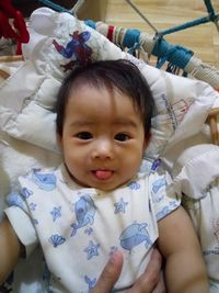 Portrait of cute baby lying on sofa