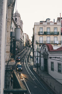 View of city street and buildings against sky