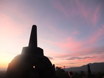 Silhouette temple against sky during sunset