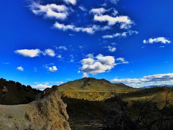 Scenic view of mountains against blue sky