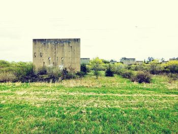 Abandoned building on field against sky