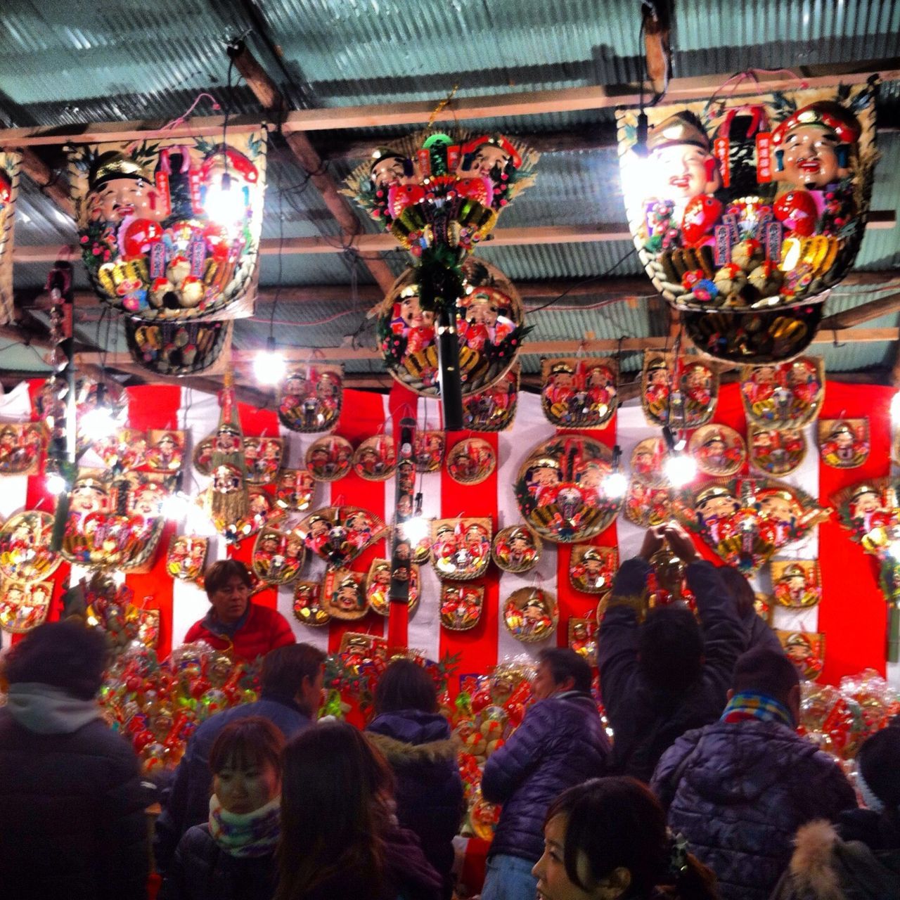 illuminated, large group of people, celebration, person, indoors, men, lifestyles, tradition, cultures, decoration, lighting equipment, leisure activity, hanging, night, lantern, traditional festival, crowd, retail, religion