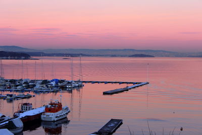 High angle view of boats sailing in sea at sunset