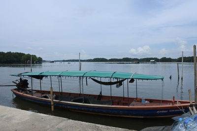 Boats moored in sea against sky