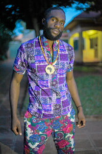 Portrait of young man standing on street