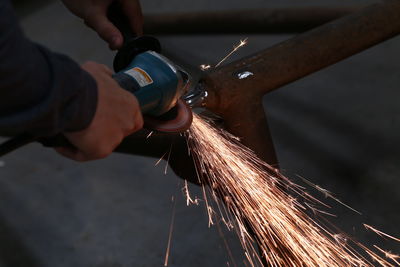 Low angle view of man working on metal in factory