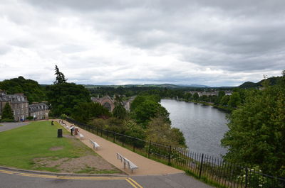 High angle view of river amidst trees against sky