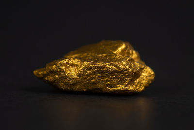 Close-up of metal on table against black background