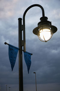 Low angle view of street light against sky at dusk