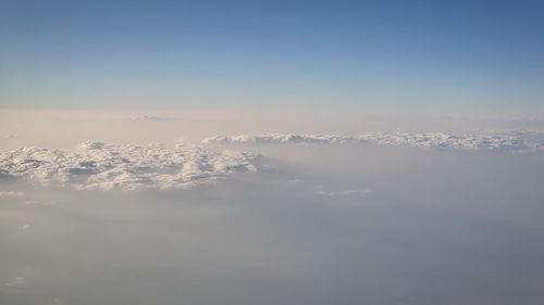 Aerial view of snowcapped mountain against sky