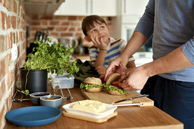 Portrait of young man preparing food on table