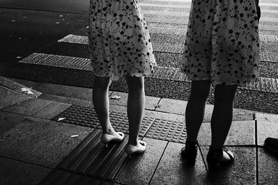 Low section of people walking on footpath