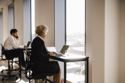 Woman in office using laptop