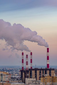 Smoke emitting from chimney against sky