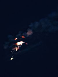 Firework display against sky at night