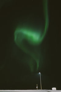 Low angle view of illuminated lights against sky at night