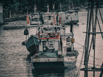 Boats moored in river