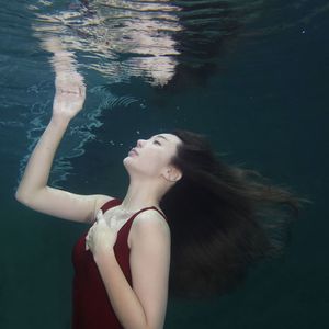 Woman looking at swimming pool in sea