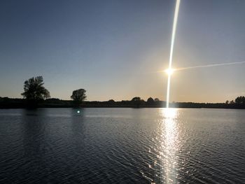 Scenic view of lake against sky at sunset