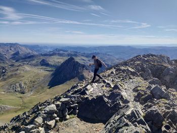 Man on rock against sky