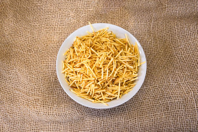 Directly above shot of noodles in bowl on jute