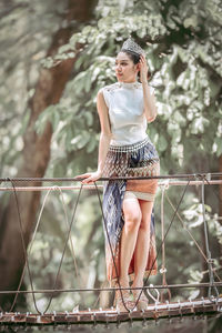 Full length of woman standing against blurred background