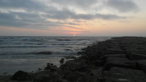 Scenic view of sea against cloudy sky