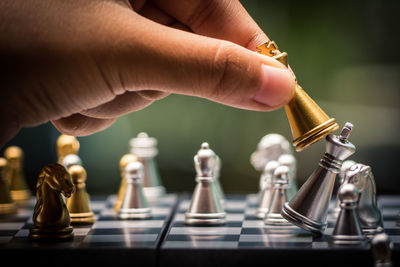 Cropped image of hand playing chess