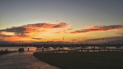 Silhouette pier over sea against sky during sunset