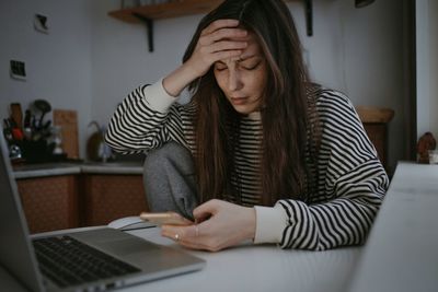 Young woman using laptop at home