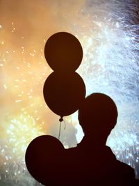 Close-up of silhouette boy holding umbrella