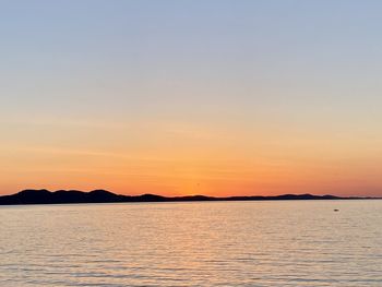 Scenic view of sea against clear sky during sunset