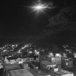 Illuminated cityscape against sky at night